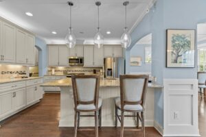 kitchen with pastel colors with natural lighting and complementing stone countertops