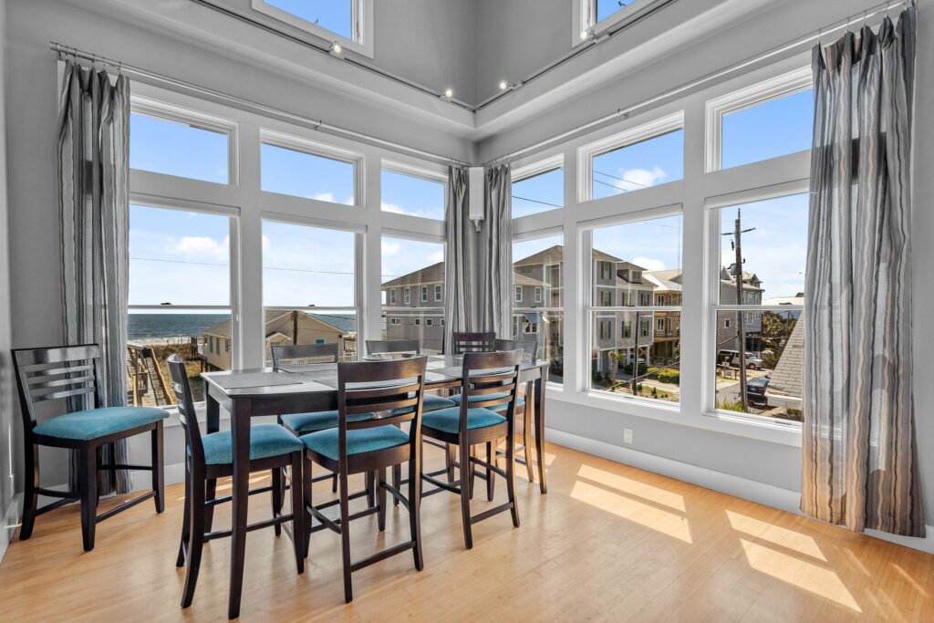 Stunning Hdr dining room with clear views from the windows overlooking the beach.